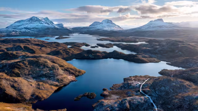 Scottish Mountains in the snow along the Cul Mor ridge by drone