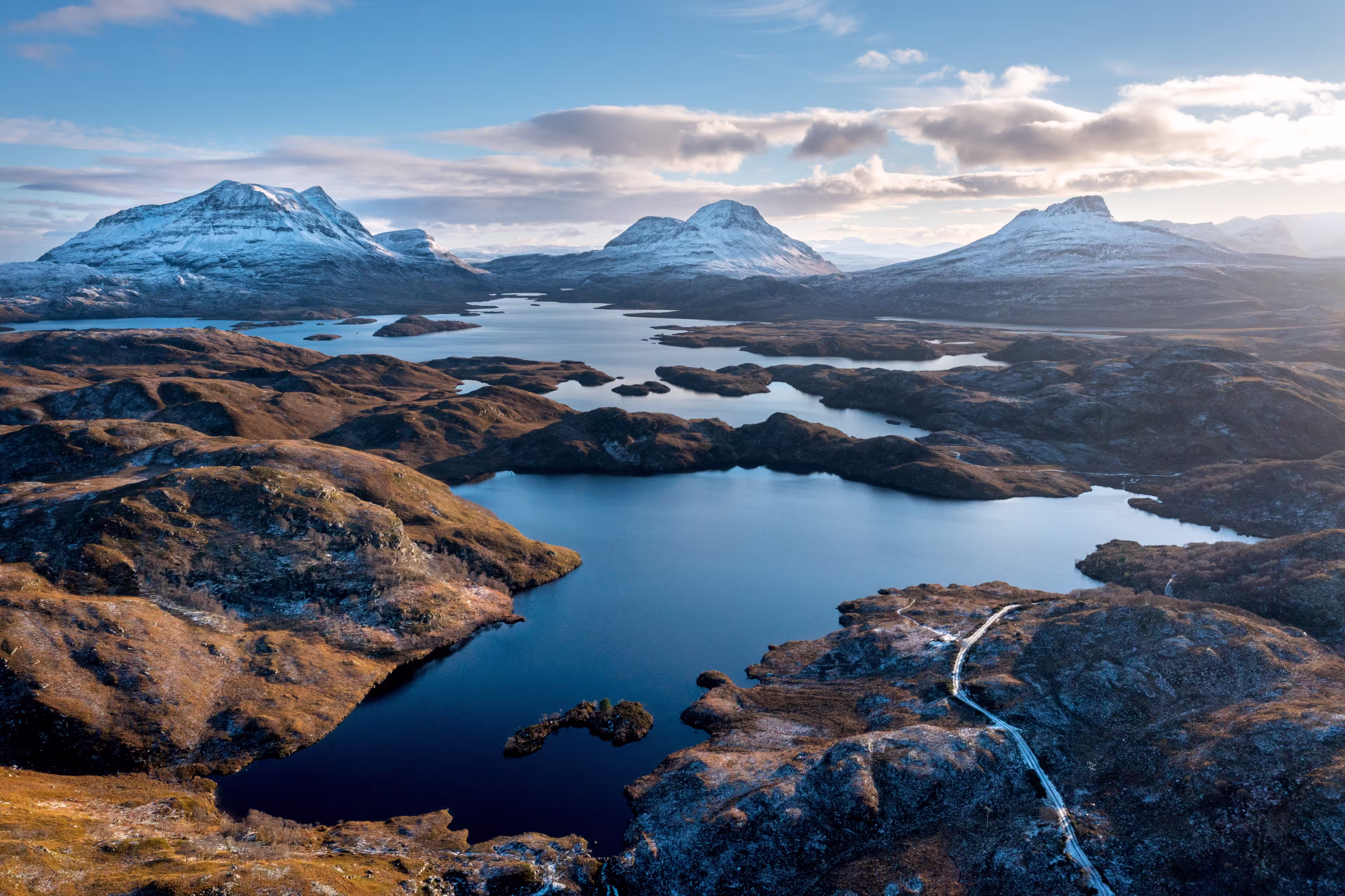 Scottish Mountains in the snow along the Cul Mor ridge by drone