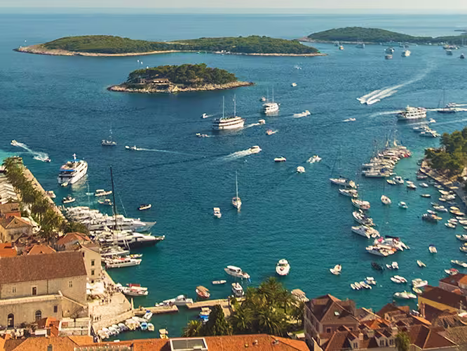 Aerial drone shot view of sailing boats cruising the Dalmatian Coast, Croatia