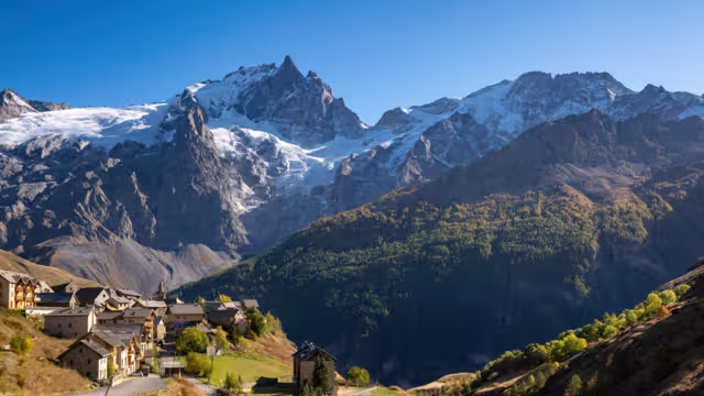 La Meije peak in Ecrins National Park with the village of Le Chazelet and glacier in Autumn. Hautes-Alpes, French Alps, France