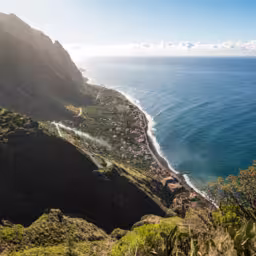 Panoramic view of Paul do Mar and the coast of Madeira near Fãja da Ovelha, seen from a Miradouro viewpoint at the "Vereda dos Zimbreiros" hiking trail