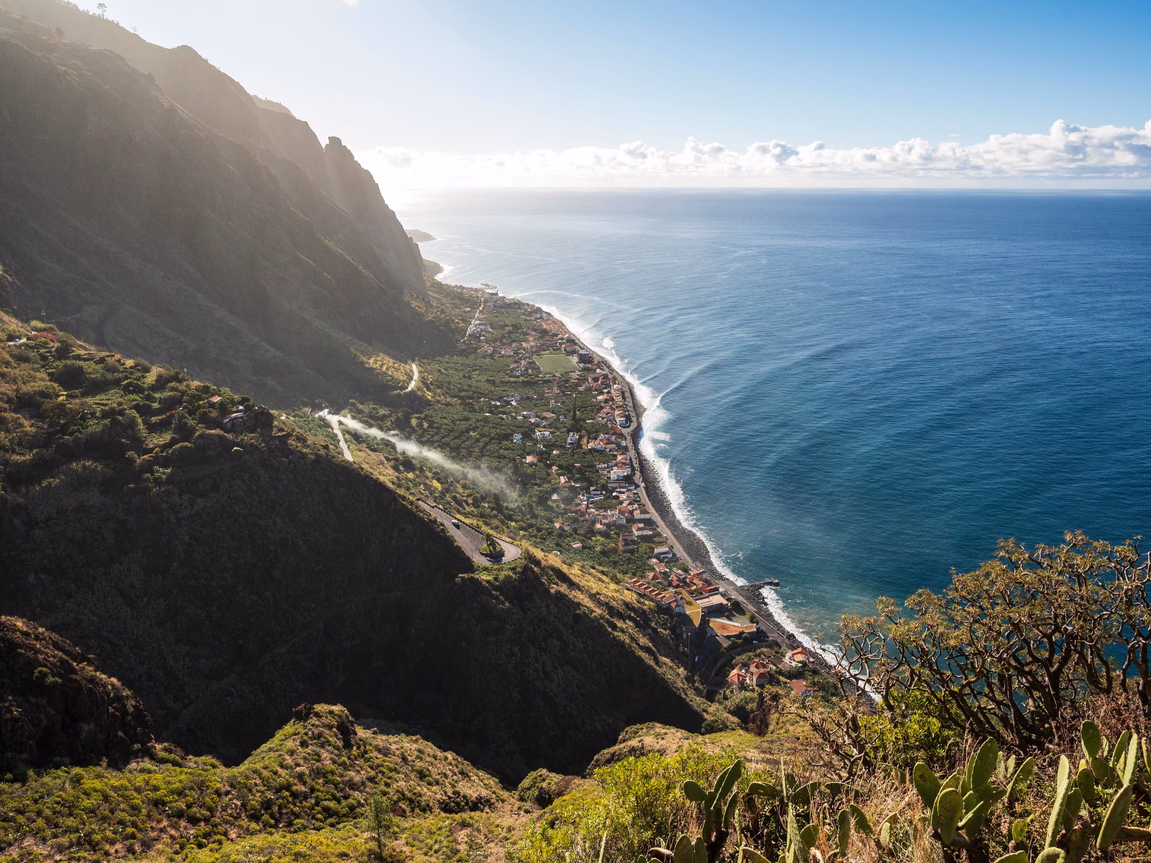 Panoramic view of Paul do Mar and the coast of Madeira near Fãja da Ovelha, seen from a Miradouro viewpoint at the "Vereda dos Zimbreiros" hiking trail