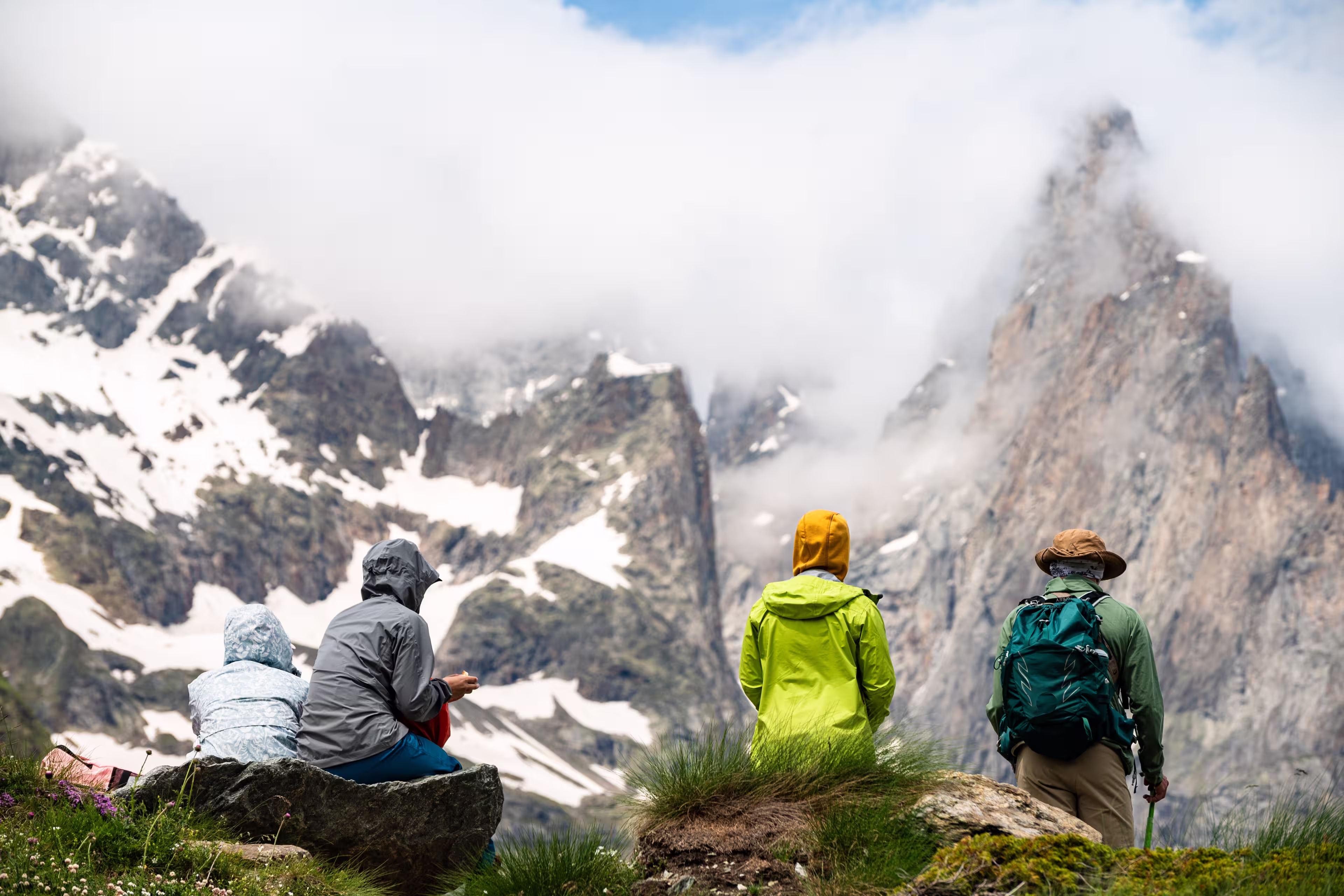 A group of tourists look at the panorama of a glacier in the Mont Blanc massif, the Alps during the famous hike - Tour du Mont Blanc