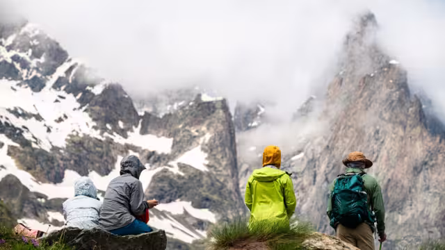 A group of tourists look at the panorama of a glacier in the Mont Blanc massif, the Alps during the famous hike - Tour du Mont Blanc