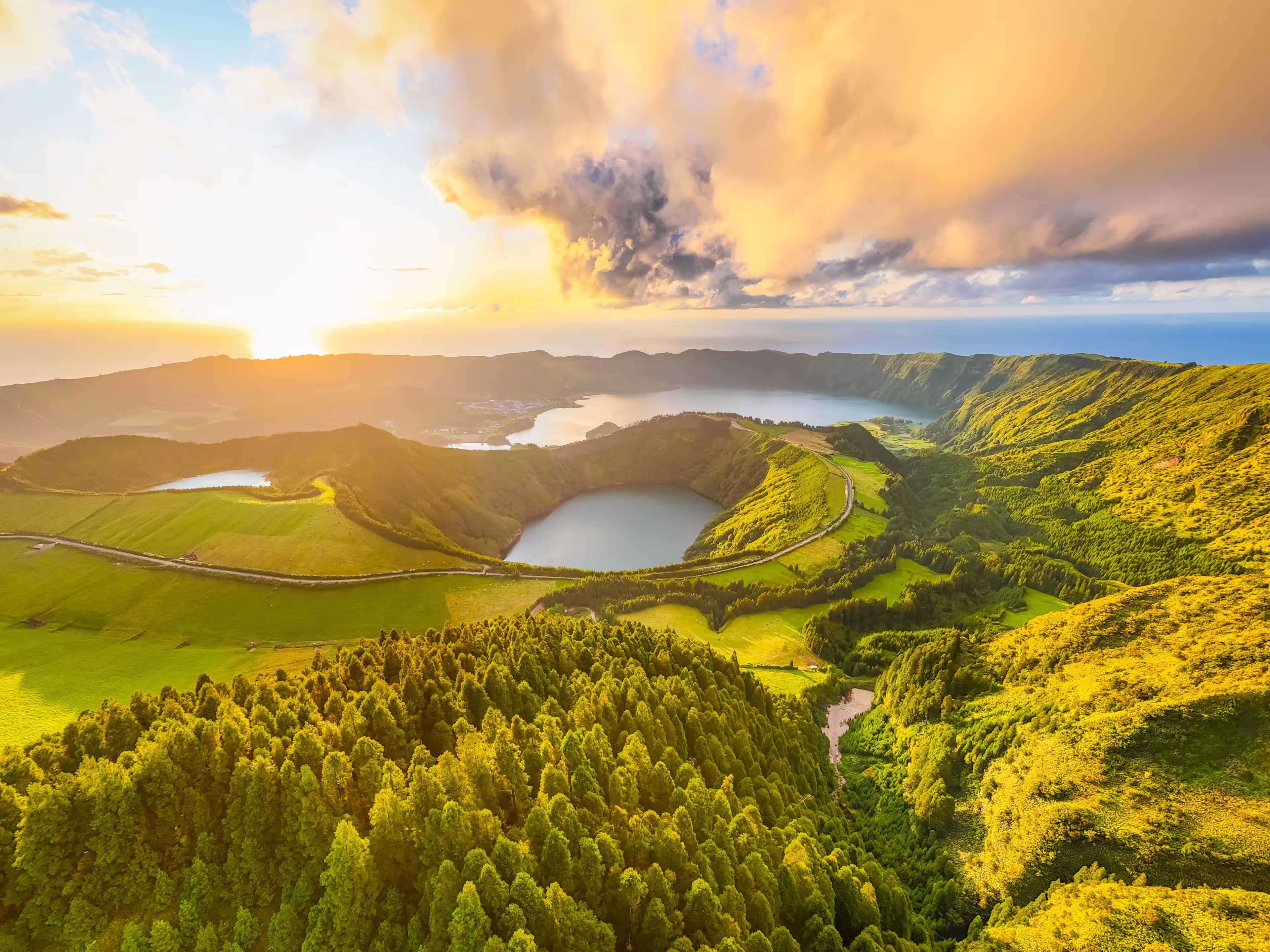 Panorama of Sete Cidades Caldera at Sunset. Blue Lake, Lake Rasa and Santiago Lake. Forest and Hills with Pasturelands. Azores, Sao Miguel Island. Portugal. Aerial Panoramic Shot