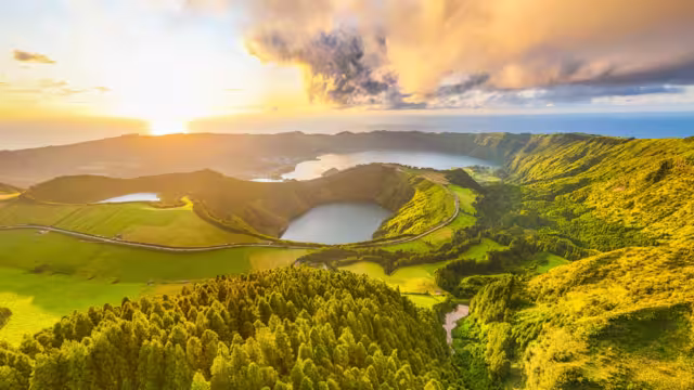 Panorama of Sete Cidades Caldera at Sunset. Blue Lake, Lake Rasa and Santiago Lake. Forest and Hills with Pasturelands. Azores, Sao Miguel Island. Portugal. Aerial Panoramic Shot