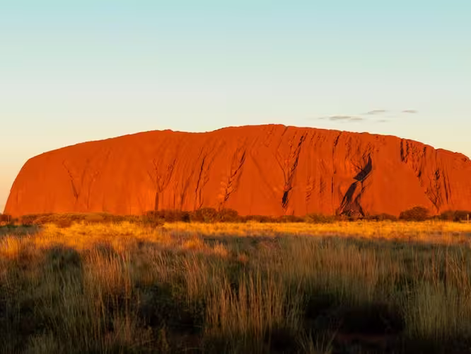 Travellers enjoy view of Uluru sunset