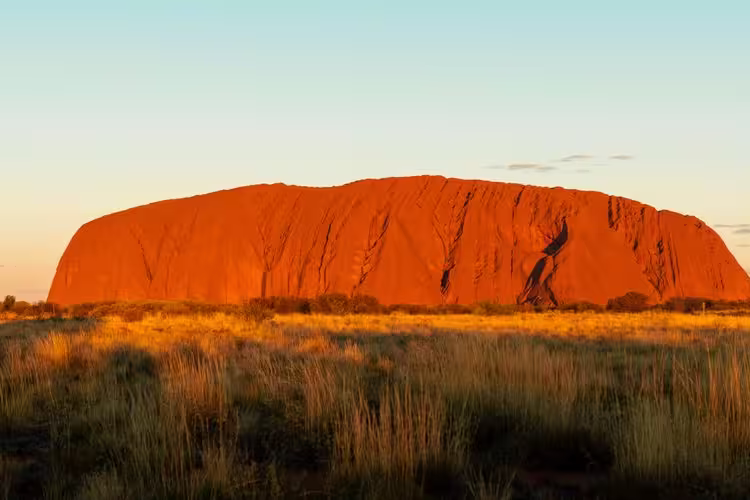 Travellers enjoy view of Uluru sunset