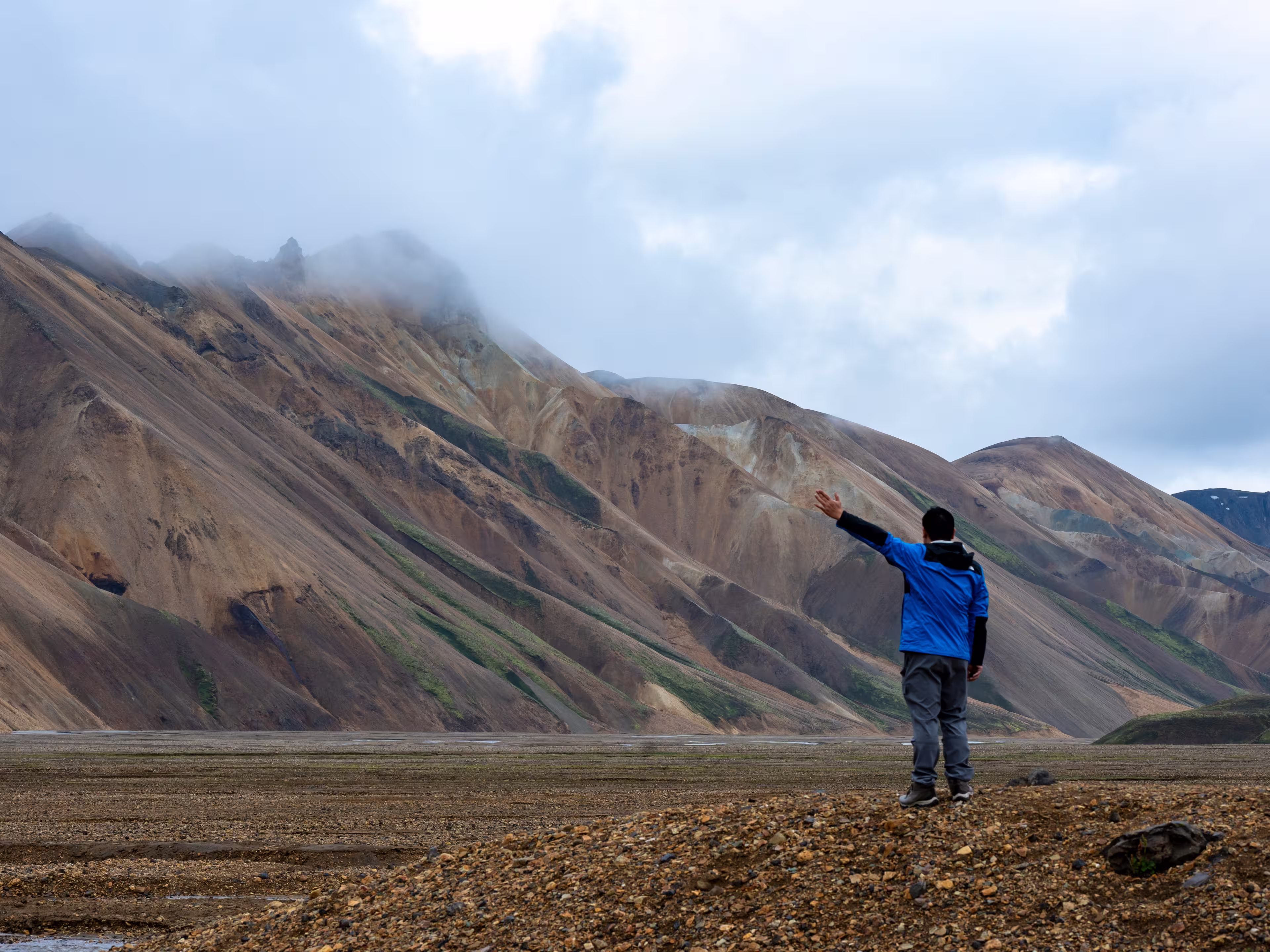 Colorful rhyolite mountains of Landmannalaugar in Iceland under moody skies. A surreal and remote highland landscape.