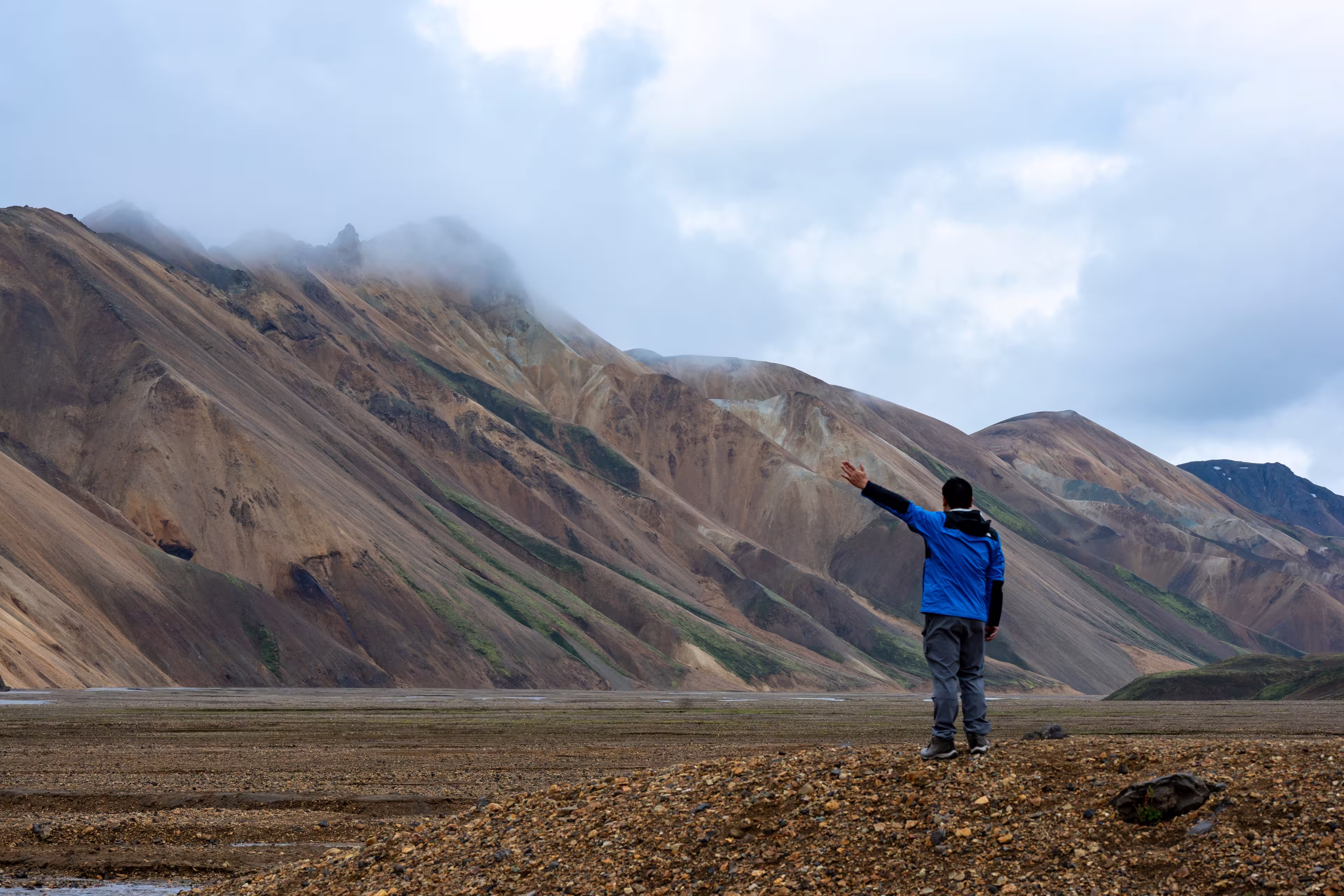 Colorful rhyolite mountains of Landmannalaugar in Iceland under moody skies. A surreal and remote highland landscape.