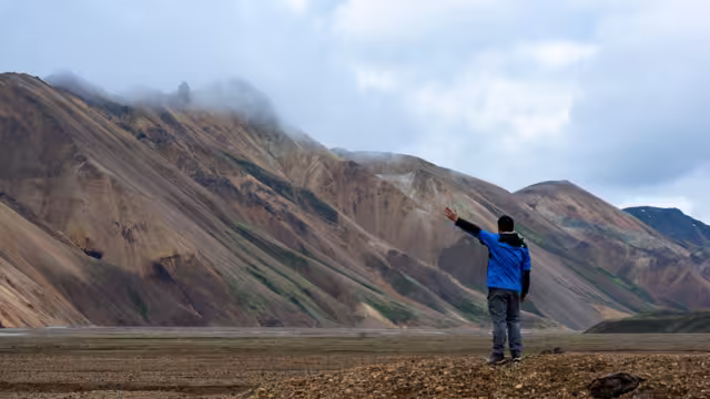 Colorful rhyolite mountains of Landmannalaugar in Iceland under moody skies. A surreal and remote highland landscape.