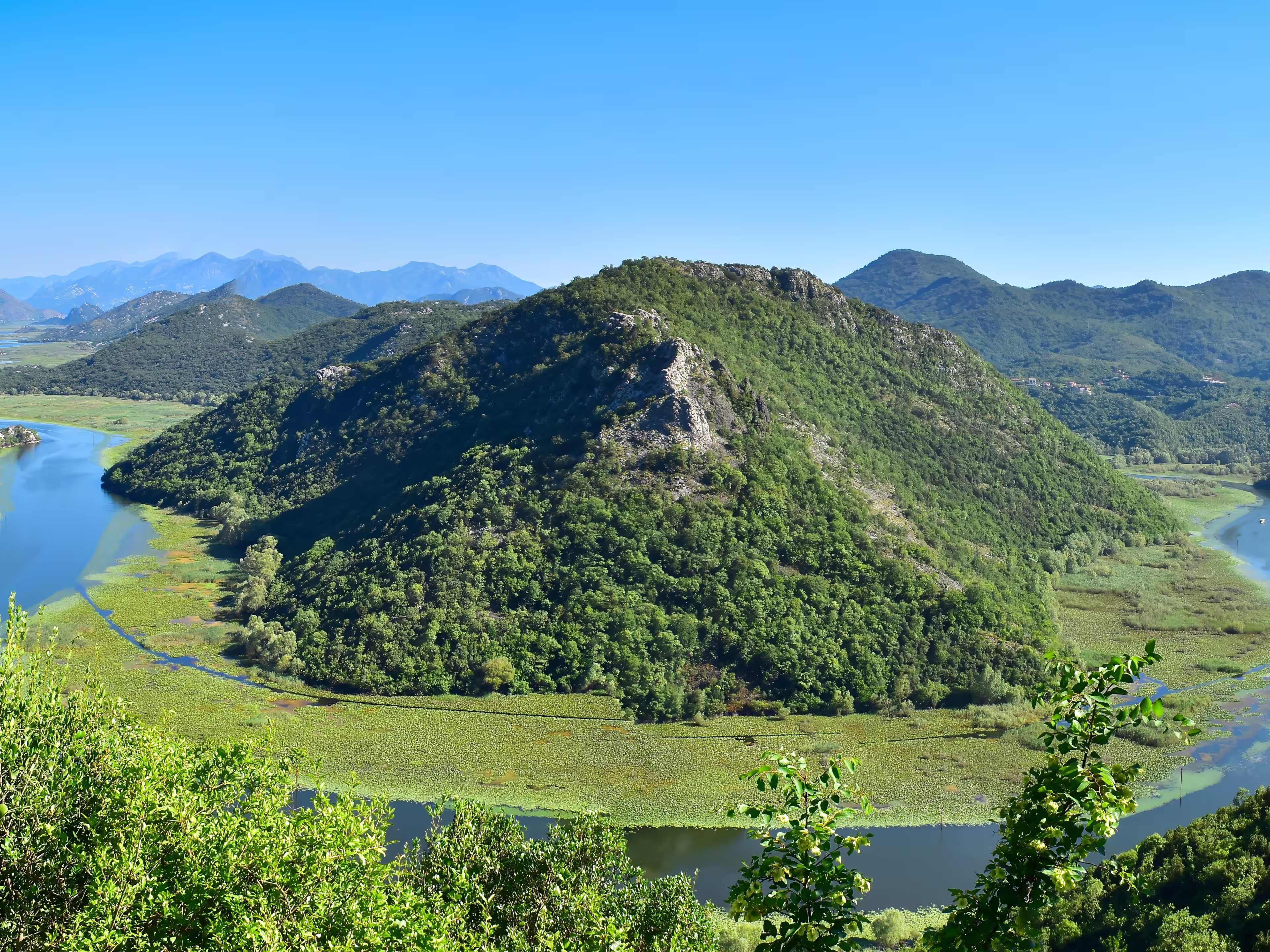 Famous river view of Skadar Lake National Park at Pavlova Strana viewpoint. Rijeka Crnojevica horseshoe bend. Scenic nature  landscape in Montenegro. Travel the Balkans, Europe.