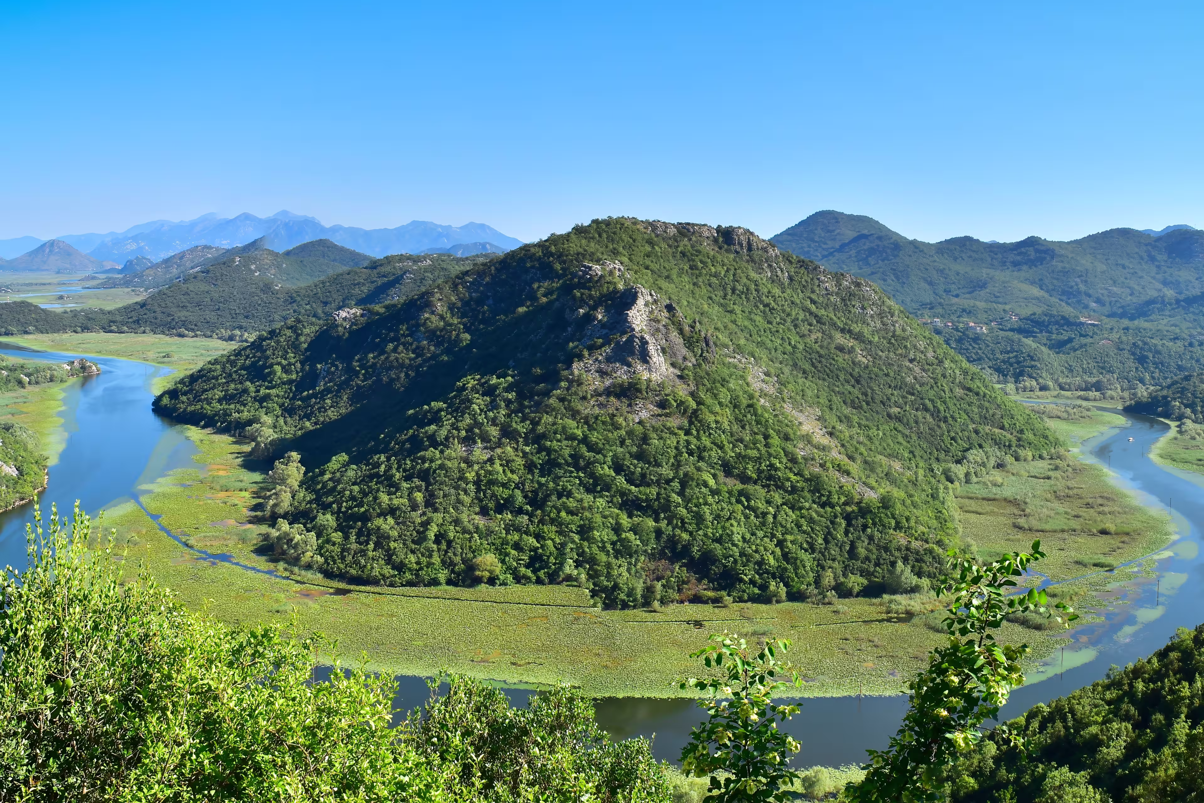 Famous river view of Skadar Lake National Park at Pavlova Strana viewpoint. Rijeka Crnojevica horseshoe bend. Scenic nature  landscape in Montenegro. Travel the Balkans, Europe.