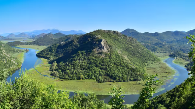 Famous river view of Skadar Lake National Park at Pavlova Strana viewpoint. Rijeka Crnojevica horseshoe bend. Scenic nature landscape in Montenegro. Travel the Balkans, Europe.