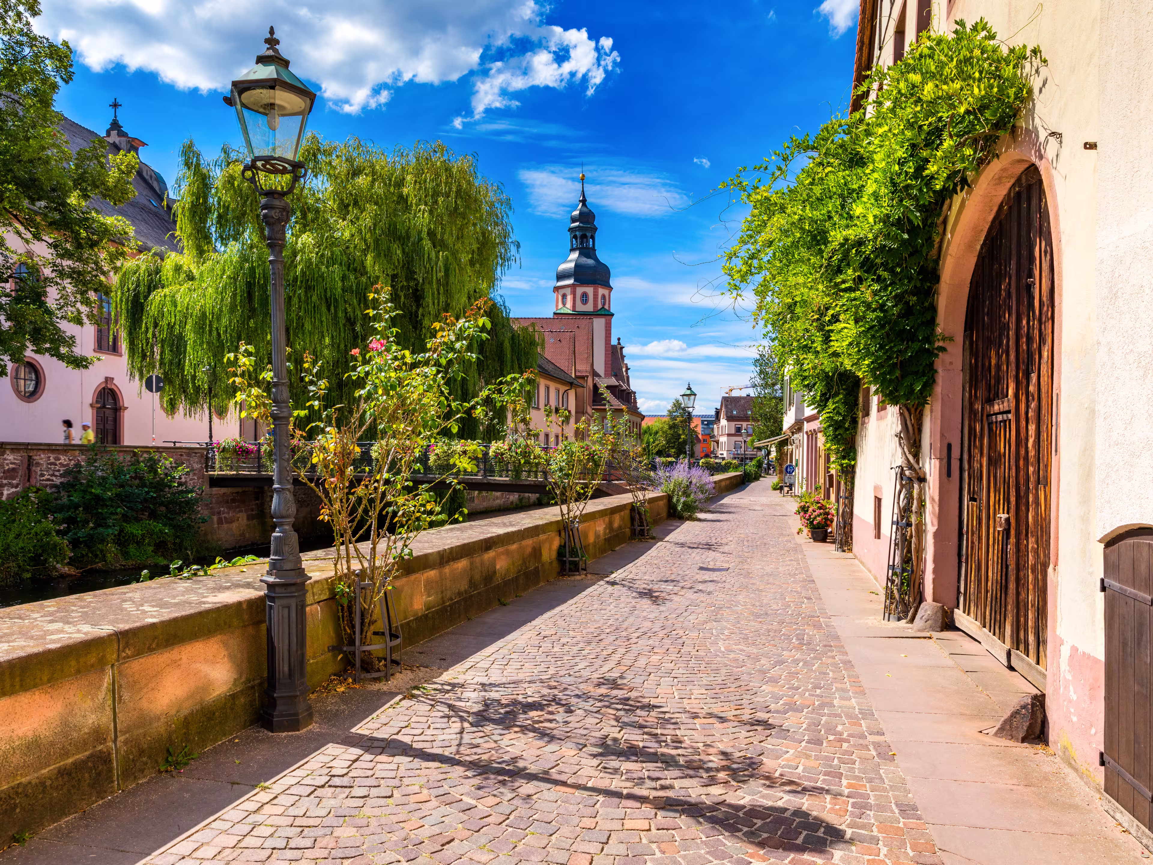 Old city of Ettlingen in Germany with a river and a church. View of a central district of Ettlingen, Germany, with a river and a bell tower of a church. Ettlingen, Baden Wurttemberg, Germany.