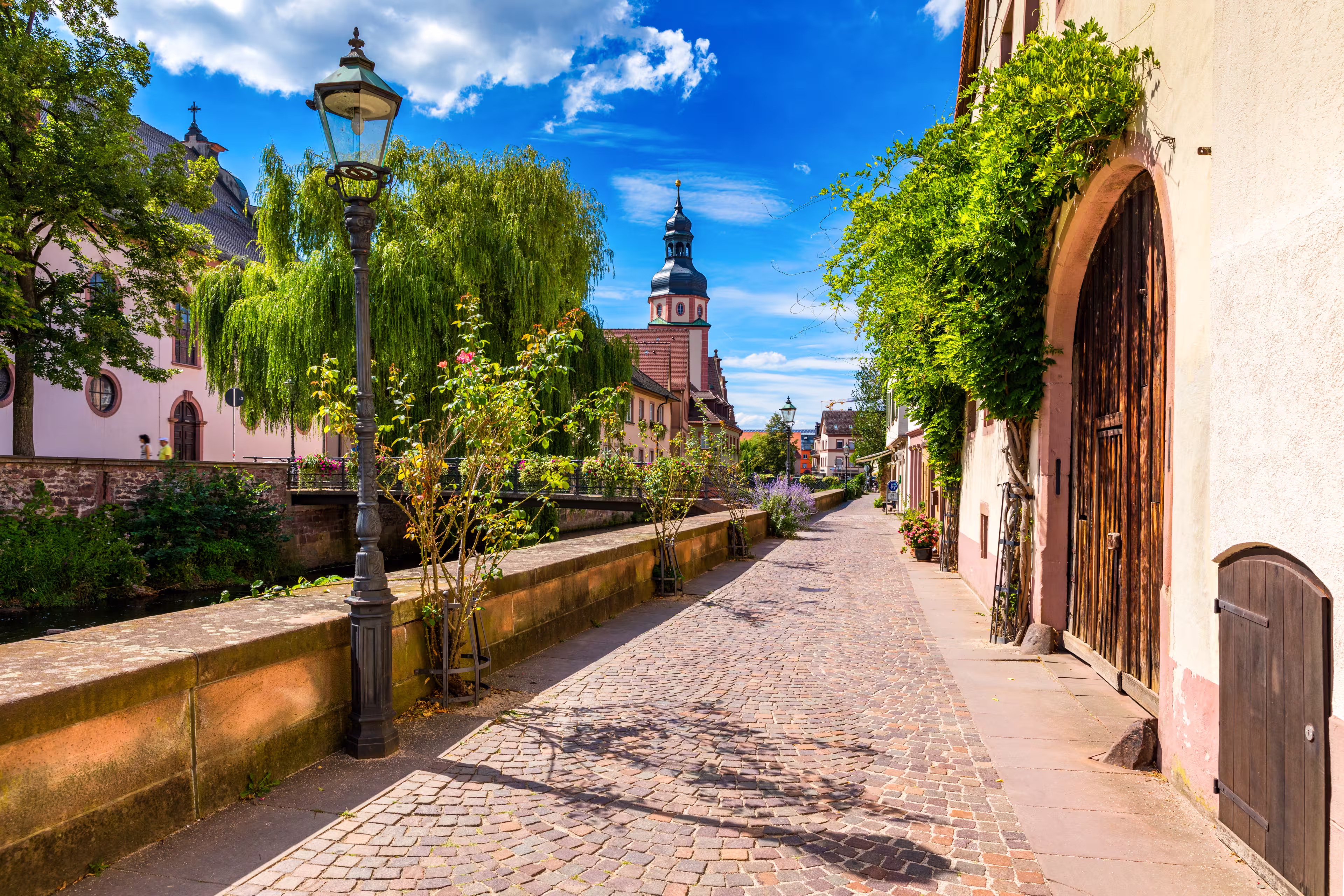 Old city of Ettlingen in Germany with a river and a church. View of a central district of Ettlingen, Germany, with a river and a bell tower of a church. Ettlingen, Baden Wurttemberg, Germany.