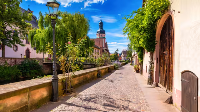 Old city of Ettlingen in Germany with a river and a church. View of a central district of Ettlingen, Germany, with a river and a bell tower of a church. Ettlingen, Baden Wurttemberg, Germany.