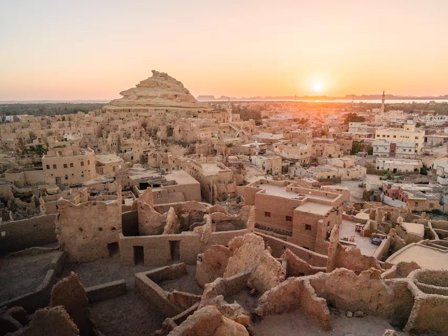 Looking out over ancient Shali town and Mount Shali at sunset, the ancient origins of Siwa Oasis from 1203