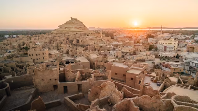 Looking out over ancient Shali town and Mount Shali at sunset, the ancient origins of Siwa Oasis from 1203