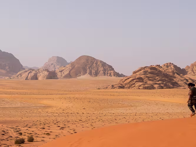 XEPJC - Group walking through desert and sand dunes, Wadi Rum