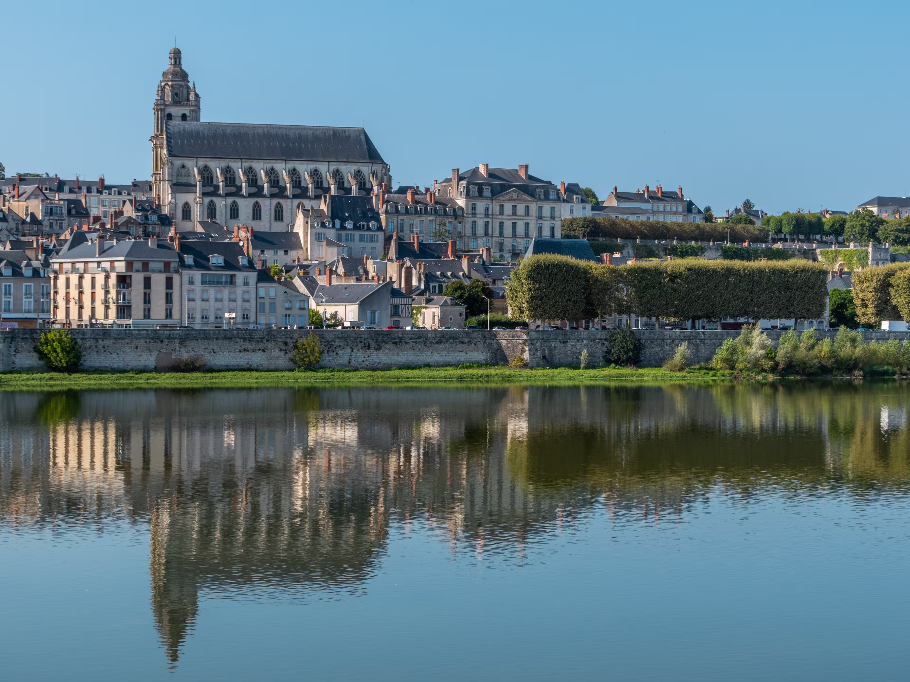 Panoramic view on Blois city and Cathedral of St. Louis , reflection on Loire river, France, wide format