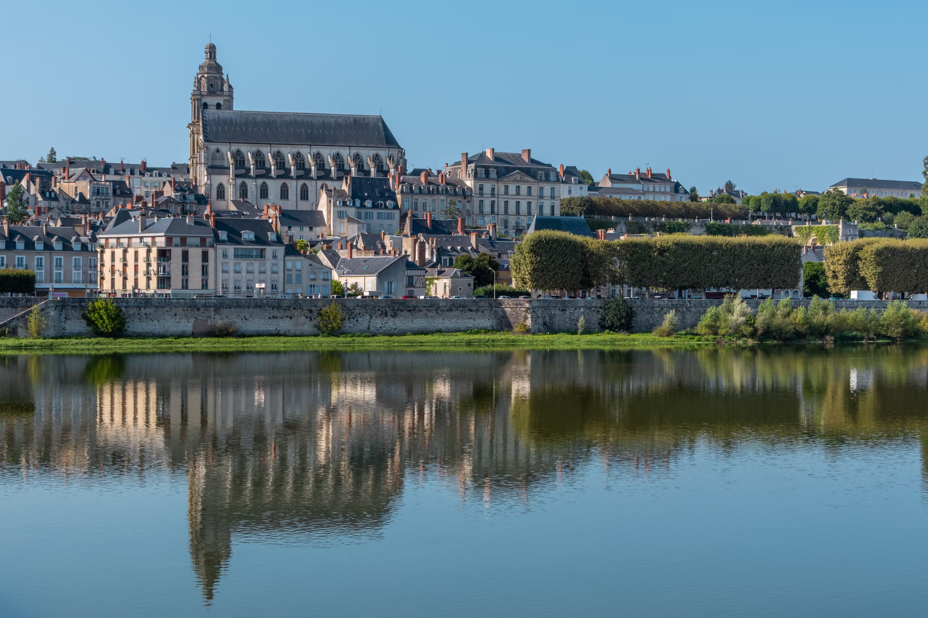 Panoramic view on Blois city and Cathedral of St. Louis , reflection on Loire river, France, wide format