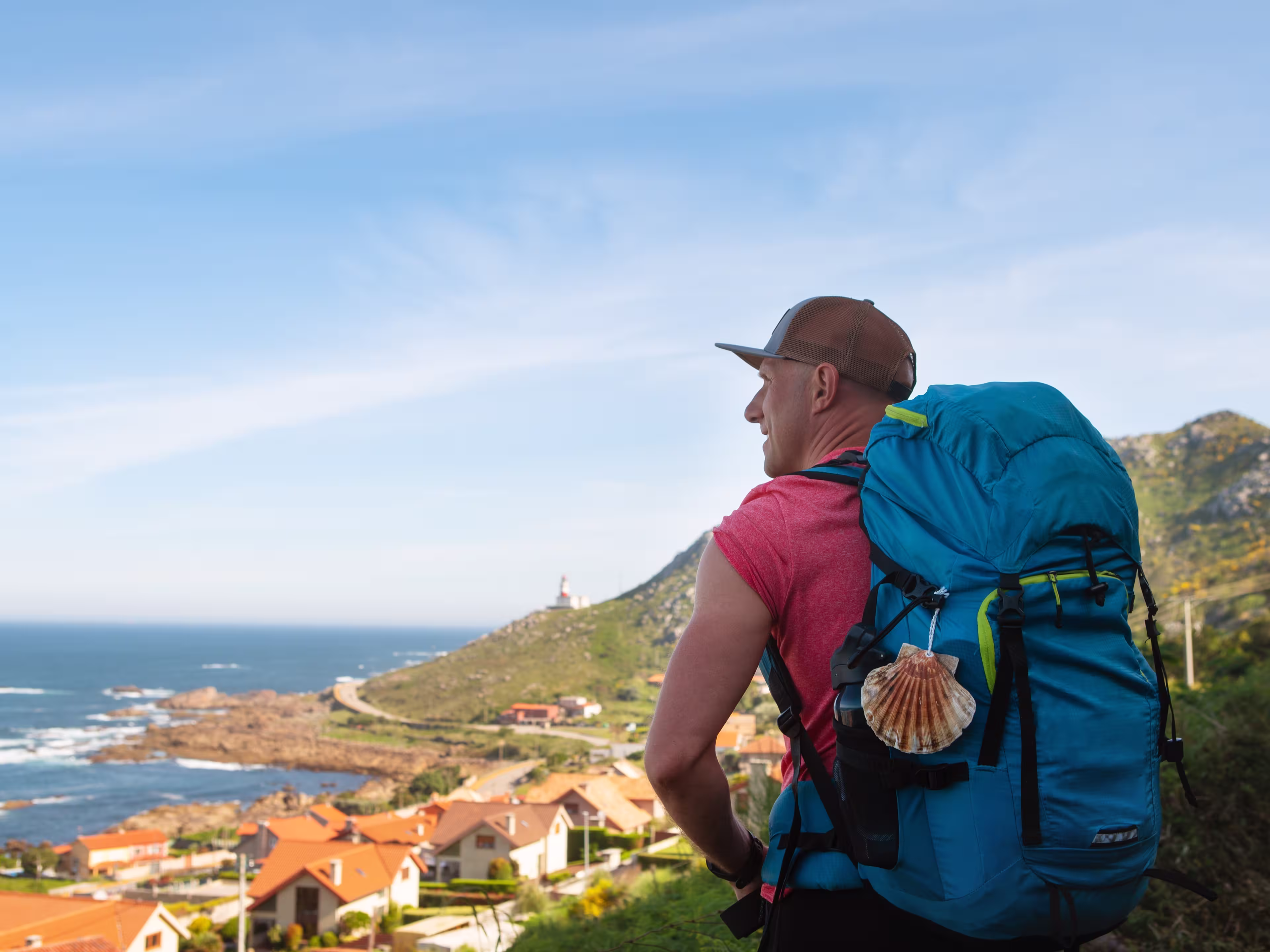 As Marinas village landscape on Spanish Atlantic coast with male pilgrim carrying backpack on Camino Portuguese Way. Inspiring walk on famous Camino de Santiago. Travel, pilgrimage, lifestyle concept