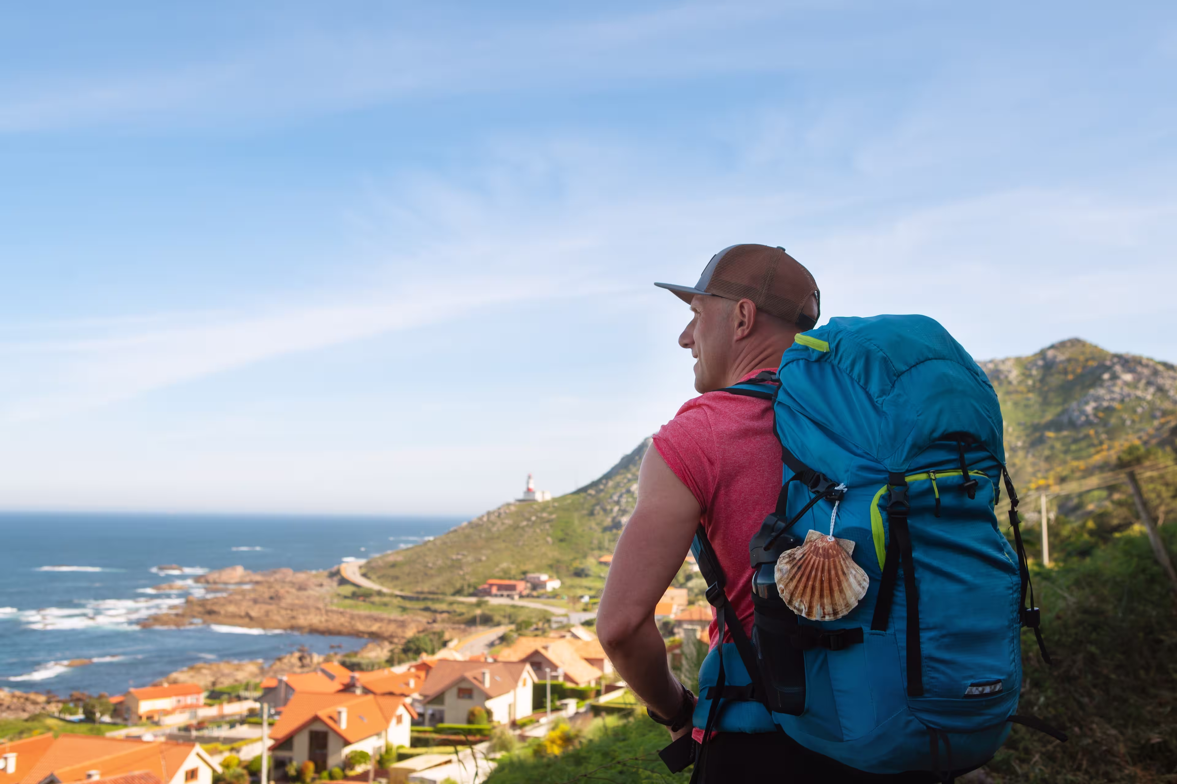As Marinas village landscape on Spanish Atlantic coast with male pilgrim carrying backpack on Camino Portuguese Way. Inspiring walk on famous Camino de Santiago. Travel, pilgrimage, lifestyle concept