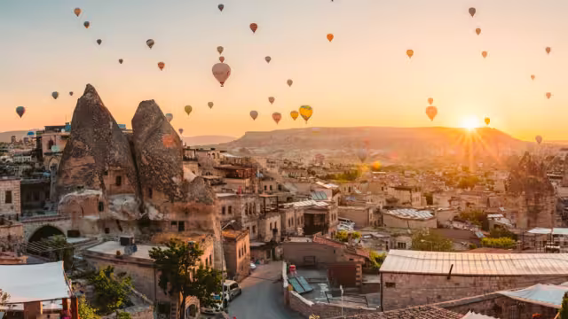 balloons at fairy chimneys at sunrise in Göreme, Cappadocia