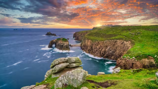 Land's End with Enys Dodman arch sunset in Cornwall. United Kiongdom