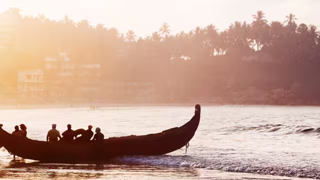 india kerala boats beach sunset silhouettes