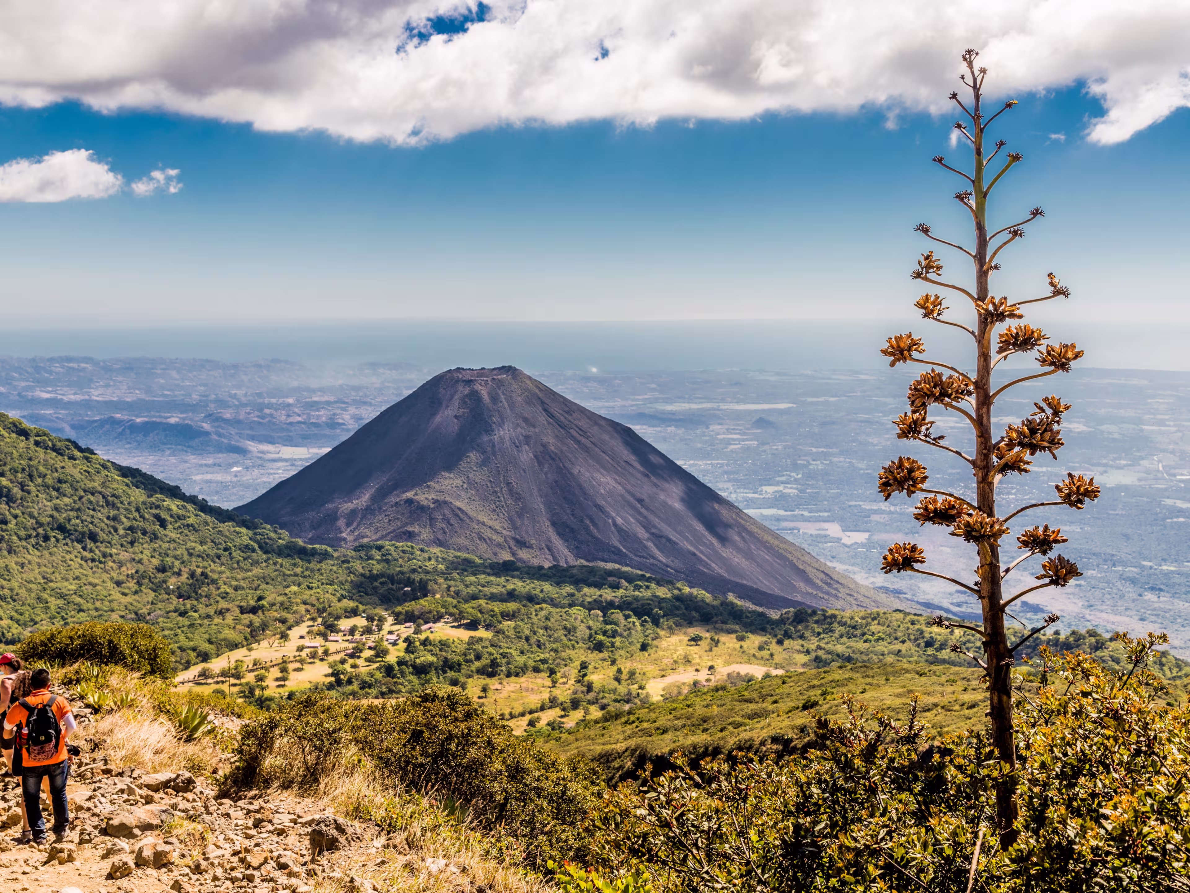 A view of Volcano Izalco and a hiker from Volcano Santa Ana (Ilamatepec ) in Santa Ana, El Salvador, Central America