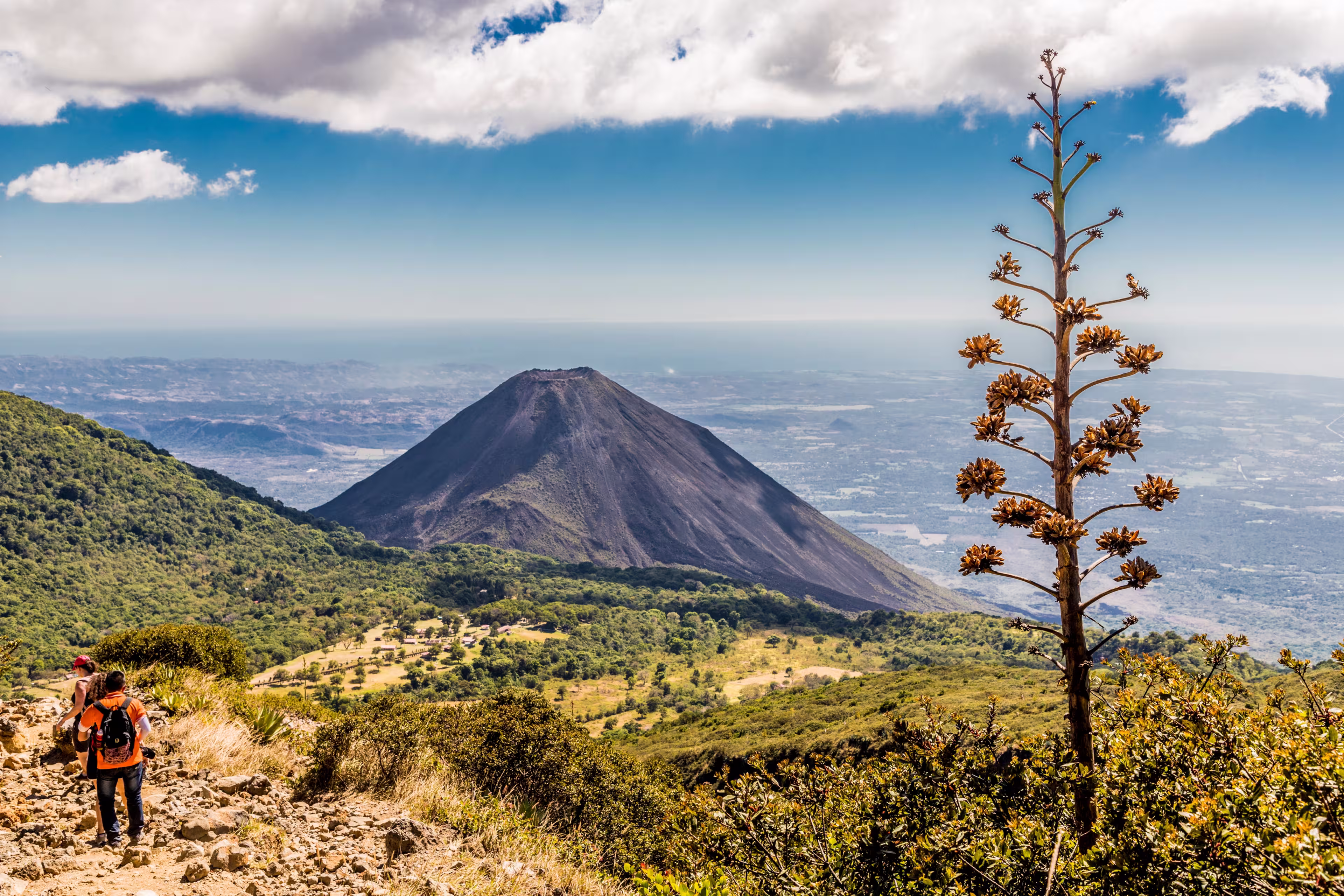 A view of Volcano Izalco and a hiker from Volcano Santa Ana (Ilamatepec ) in Santa Ana, El Salvador, Central America