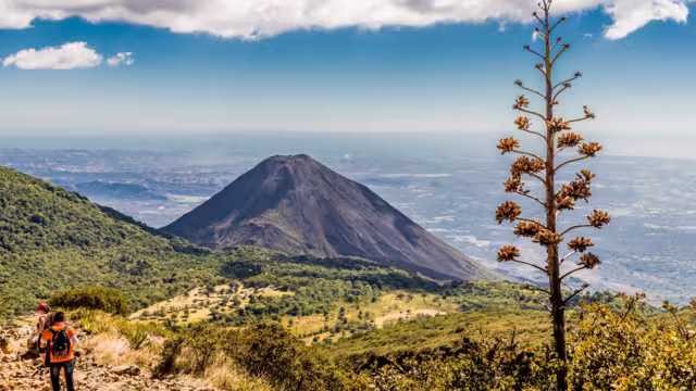 A view of Volcano Izalco and a hiker from Volcano Santa Ana (Ilamatepec ) in Santa Ana, El Salvador, Central America