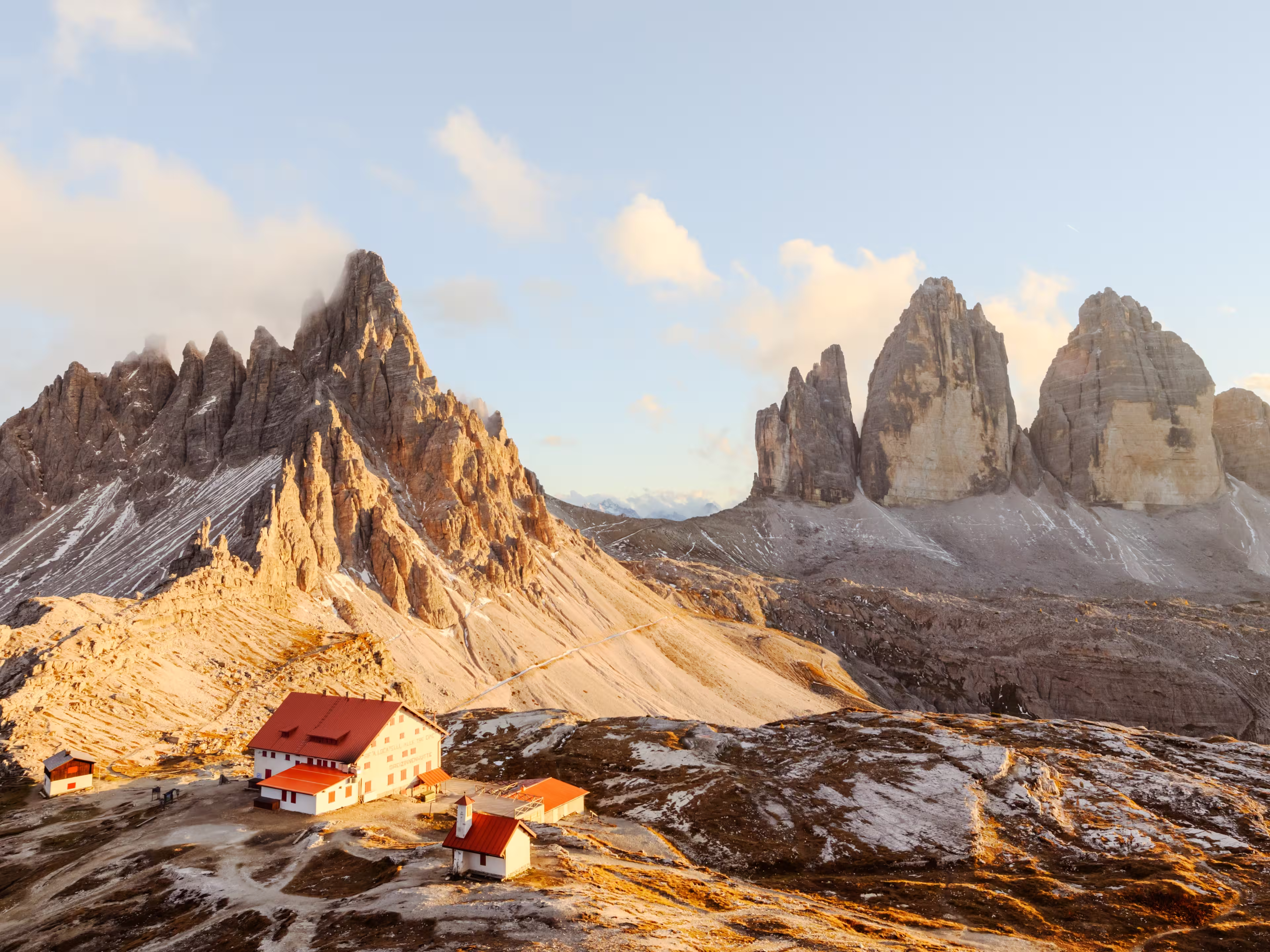 Panoramic view on Tre Cime di Lavaredo and rifugio Locatelli in Dolomite Alps during sunset. Three peaks of Lavaredo, Dolomites, South Tyrol, Italy, Europe. Landscape photography panorama