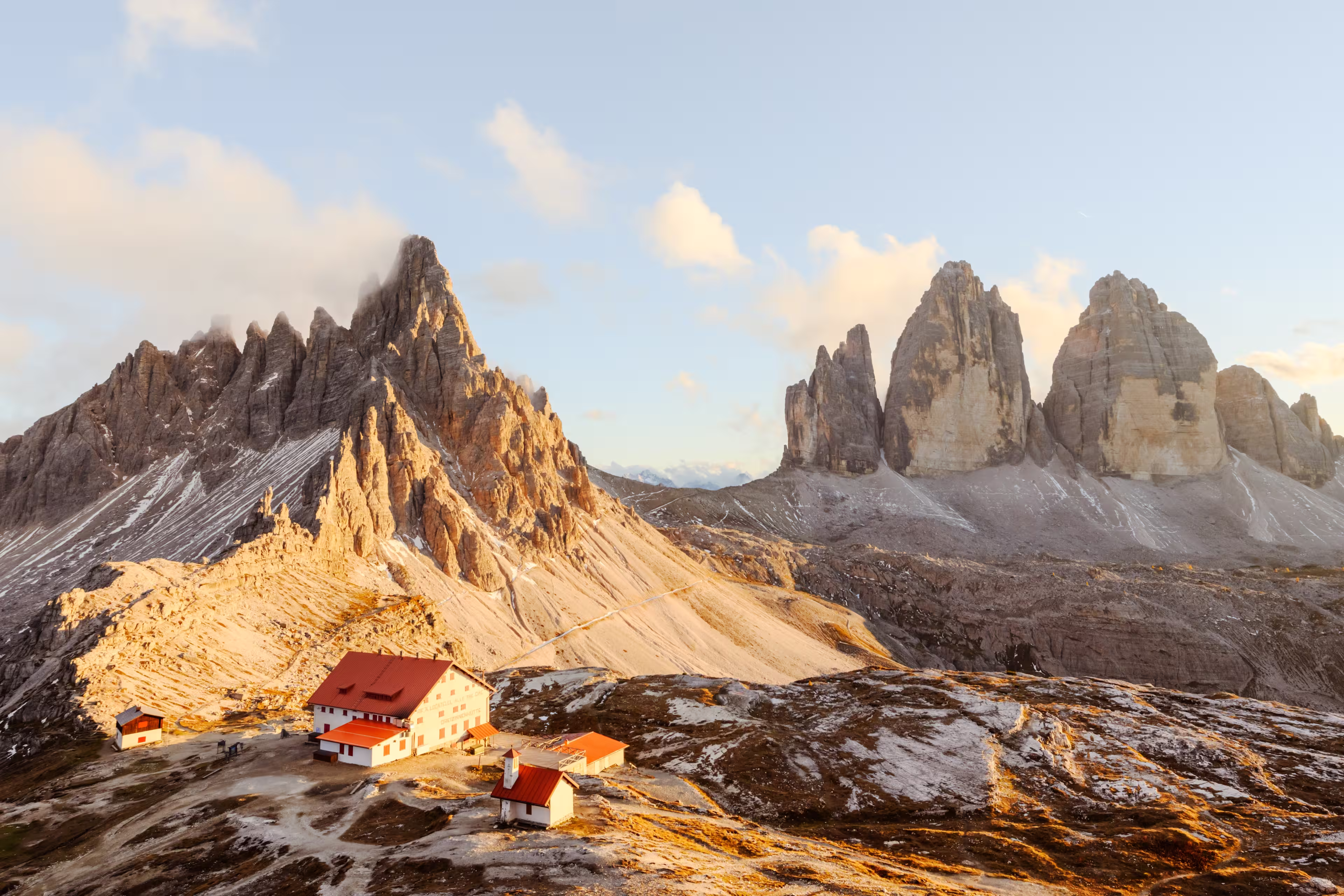 Panoramic view on Tre Cime di Lavaredo and rifugio Locatelli in Dolomite Alps during sunset. Three peaks of Lavaredo, Dolomites, South Tyrol, Italy, Europe. Landscape photography panorama