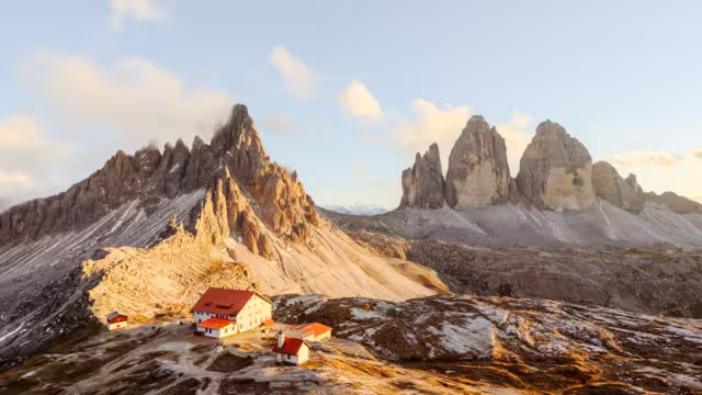 Panoramic view on Tre Cime di Lavaredo and rifugio Locatelli in Dolomite Alps during sunset. Three peaks of Lavaredo, Dolomites, South Tyrol, Italy, Europe. Landscape photography panorama