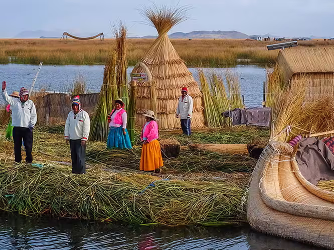 Local villagers wave welcome on floating islands, Lake Titicaca, Peru