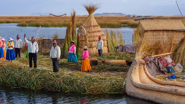 Local villagers wave welcome on floating islands, Lake Titicaca, Peru