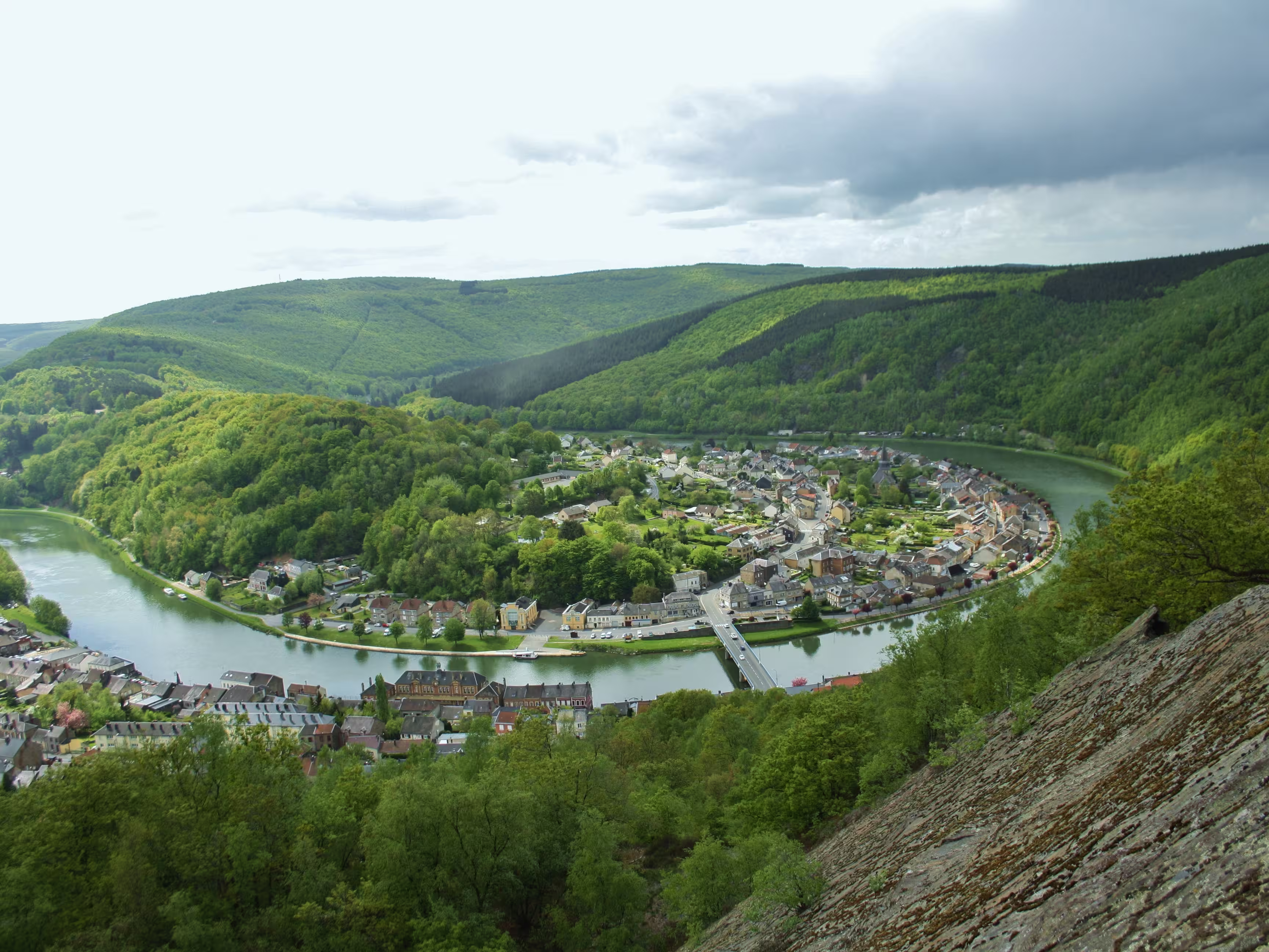 Panoramic view on green hills, french village, Meuse river meandering, from La roche a Sept-Heures, Monthermé, Ardennes, France