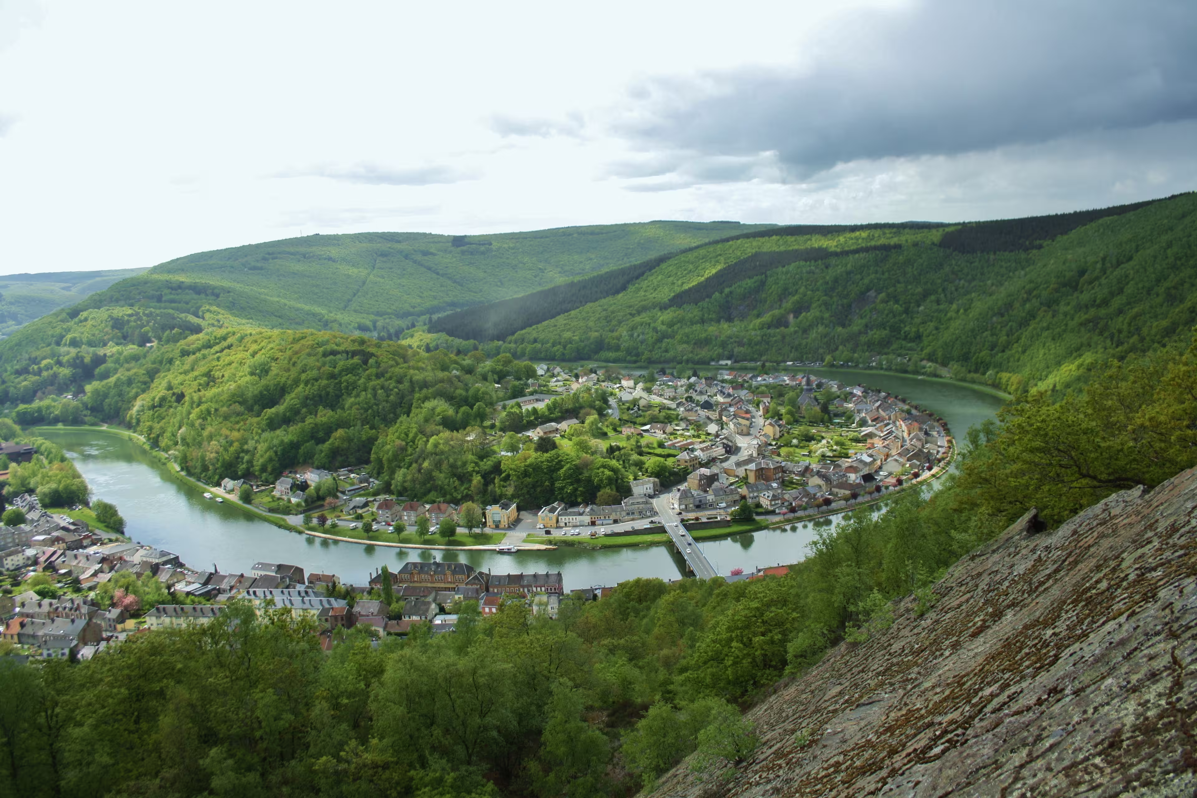 Panoramic view on green hills, french village, Meuse river meandering, from La roche a Sept-Heures, Monthermé, Ardennes, France
