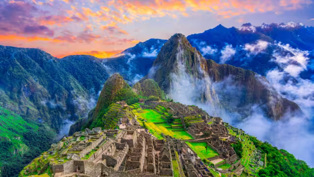 Machu Picchu, Cusco,Peru: Overview of the lost inca city Machu Picchu, agriculture terraces and Wayna Picchu, peak in the background,before sunrise