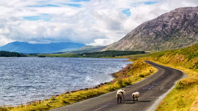 Scenic Inagh Valley during long days of Irish summer. Beautiful landscape of surrounding mountains called Twelve Bens