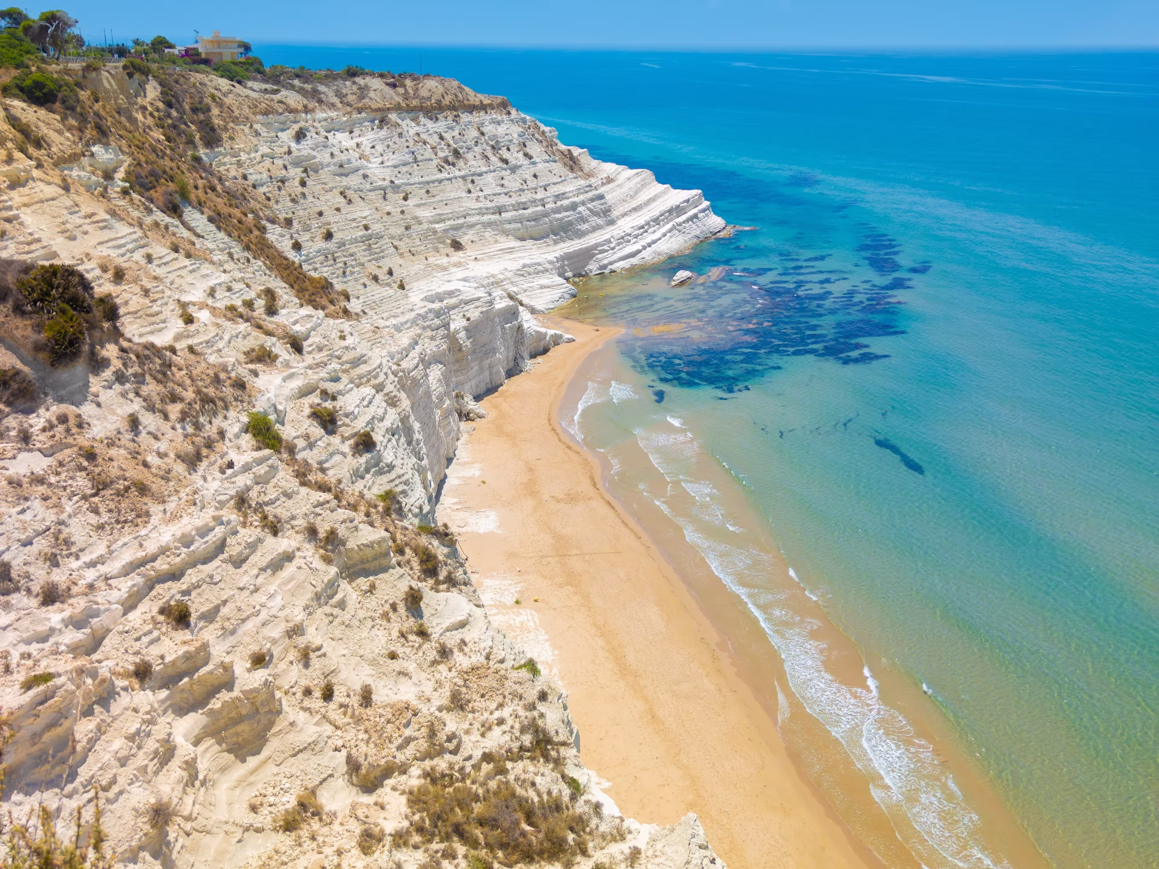 Scala dei Turchi (Italy) - The very famous white rocky cliff on the coast in the municipality of Porto Empedocle, province of Agrigento, Sicily, with beatiful golden beach and blue sea.