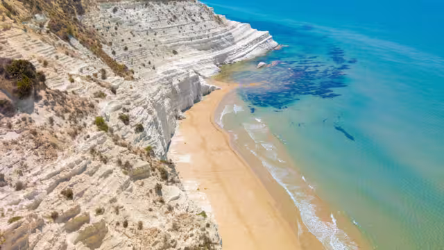 Scala dei Turchi (Italy) - The very famous white rocky cliff on the coast in the municipality of Porto Empedocle, province of Agrigento, Sicily, with beatiful golden beach and blue sea.