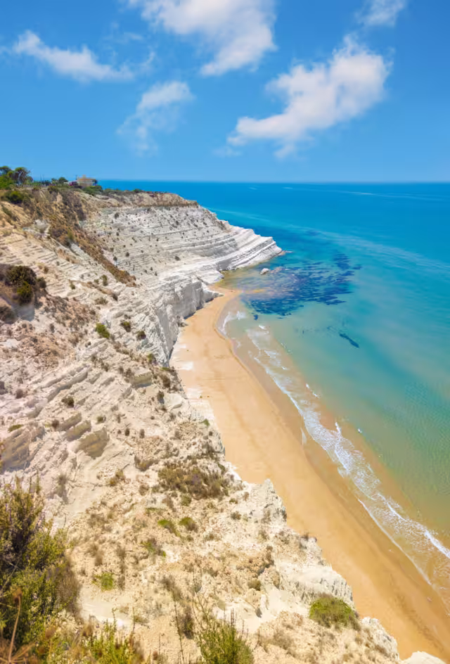 Scala dei Turchi (Italy) - The very famous white rocky cliff on the coast in the municipality of Porto Empedocle, province of Agrigento, Sicily, with beatiful golden beach and blue sea.