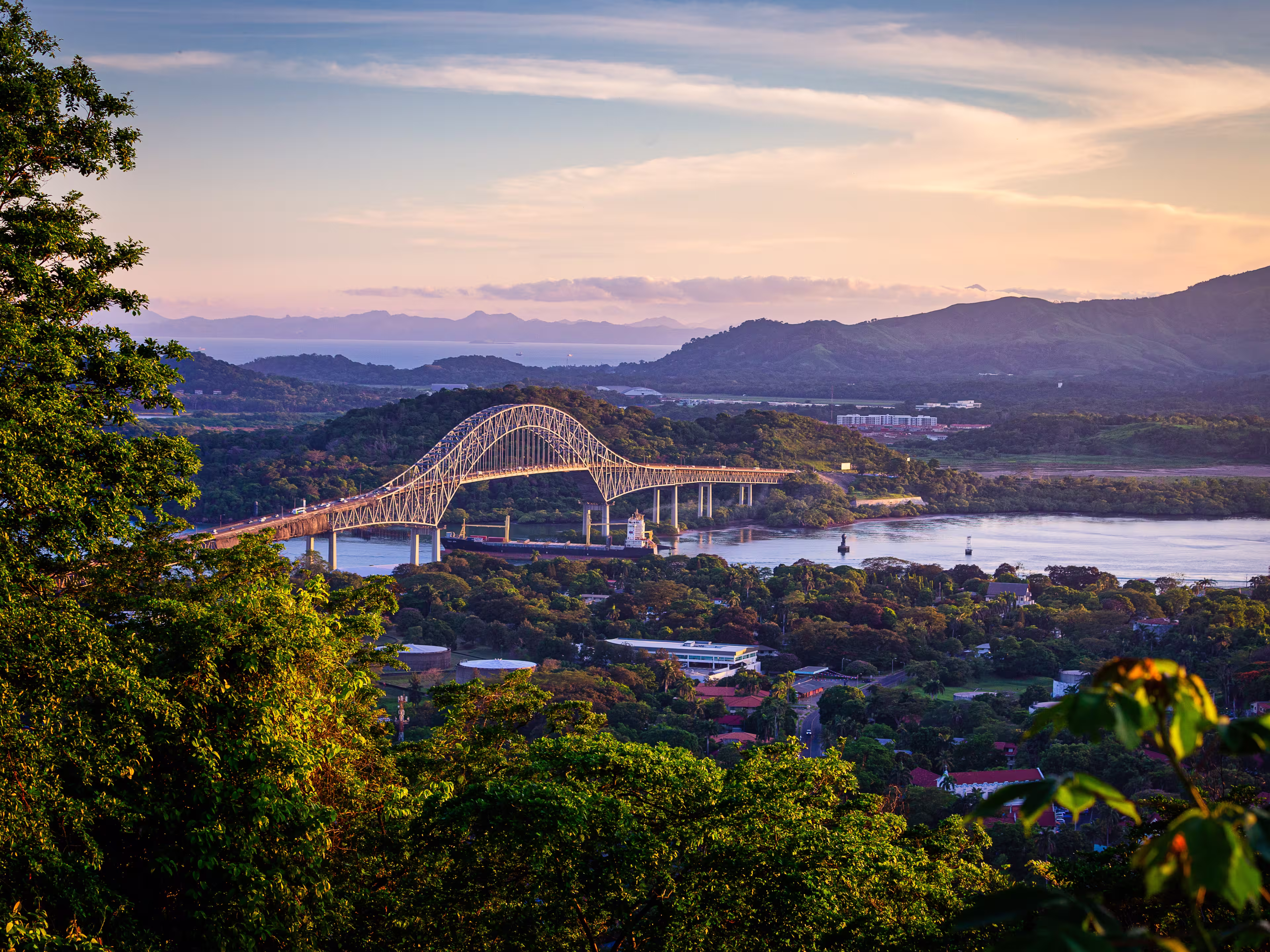 Container ship passing througha in scenic landscape