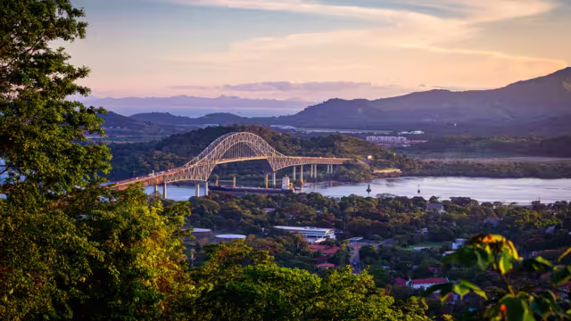 Container ship passing througha in scenic landscape
