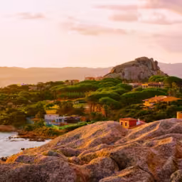 Landscape and scenery of Baja Sardinia luxury resort in Costa Smeralda at sunset evening, Sardegna island in Italy in summer. Olbia province. Villas And Mediterranean sea. Mixed media.