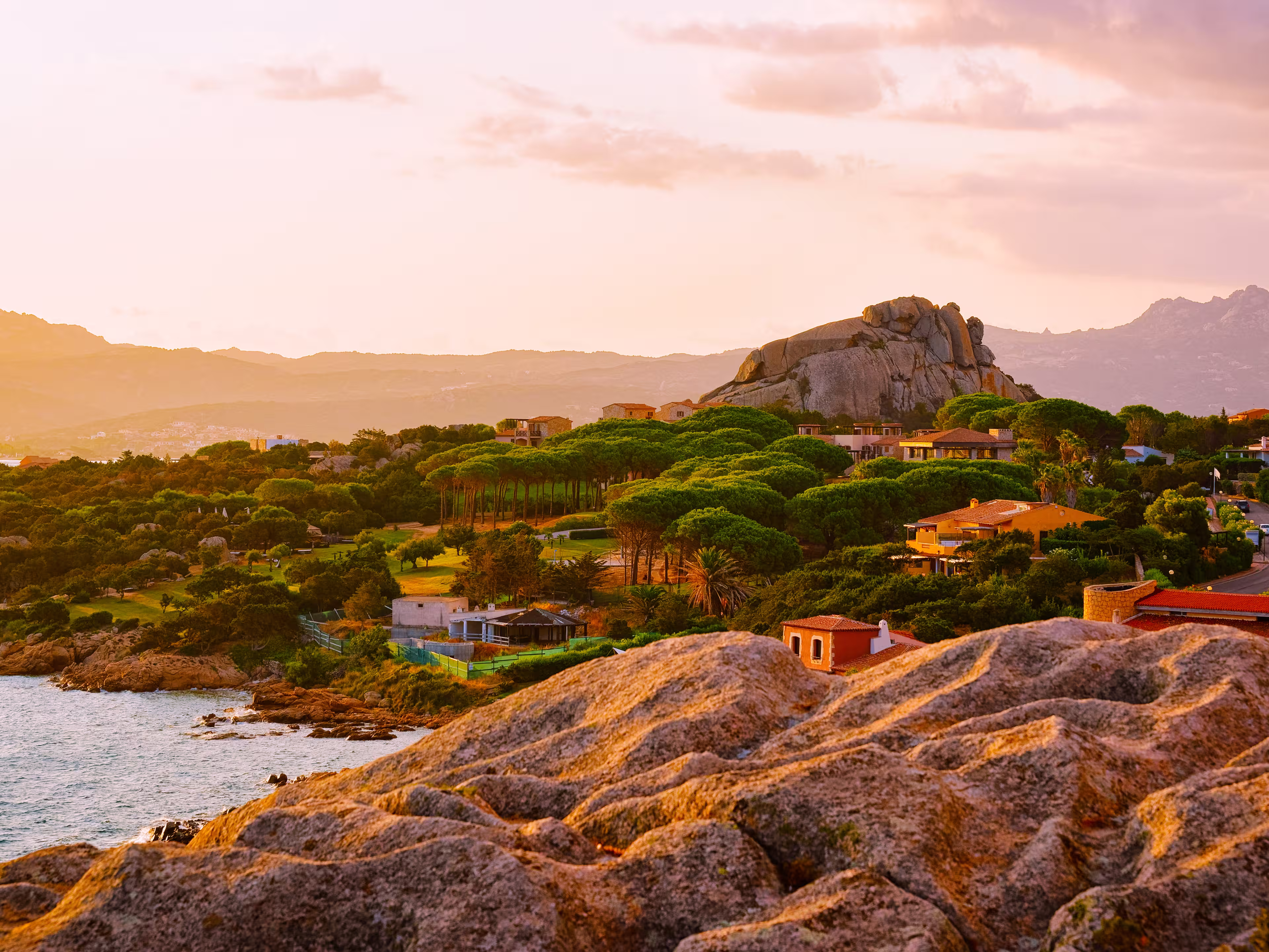 Landscape and scenery of Baja Sardinia luxury resort in Costa Smeralda at sunset evening, Sardegna island in Italy in summer. Olbia province. Villas And Mediterranean sea. Mixed media.
